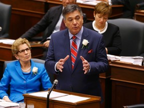 Ontario Finance Minister Charles Sousa (R) delivers the provincial budget  as Ontario Premiere Kathleen Wynne looks on at Queens Park in Toronto, May 1, 2014.  REUTERS/Mark Blinch