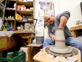 Chris Snedden works on a tall vase in his studio at the London Potters Guild on Dundas Street. (CRAIG GLOVER/The London Free Press)