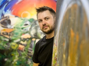 London artist Bryan Jesney shows off one of his latest pieces in his Heather Cres. studio in London.  Jesney is one of several artists featured in the 2014 London Artists? Studio Tour this weekend. (CRAIG GLOVER/The London Free Press)