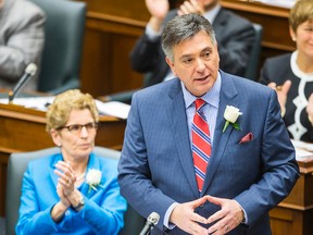 Ontario Premier Kathleen Wynne looks on as Finance Minister Charles Sousa as he announces the provincial budget at Queen's Park in Toronto, Ont.  on Thursday May 1, 2014. Ernest Doroszuk/Toronto Sun/QMI Agency