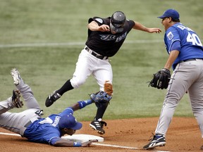 Kansas City Royals starting pitcher Runelvys Hernandez reacts as Toronto Blue Jays base runner Reed Johnson (C) is tagged out at third base by Angel Berroa (L) during the first inning of their game in 2006. (Reuters)