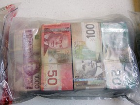 FILE: A portion of seized drug money at the downtown Police Headquarters in Edmonton, Alberta on Apr 28, 2011.  Edmonton city police made a $1 million drug bust, the largest in their history. PERRY MAH/EDMONTON SUN