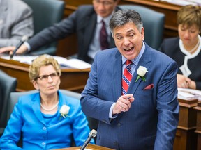 Ontario Premier Kathleen Wynne looks on as Finance Minister Charles Sousa announces the provincial budget at Queen's Park in Toronto, on Thursday. 
Ernest Doroszuk/Toronto Sun/QMI Agency