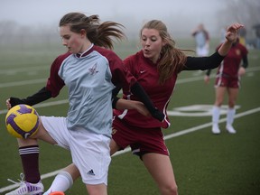 Zoe Tremblay, right, from Regiopolis–Notre Dame, collides with Maddie O'Neill of Frontenac during a Kingston senior girls soccer game at Queen’s University's West Campus on Thursday. Regi won 1-0. (Justin Greaves/For The Whig-Standard)