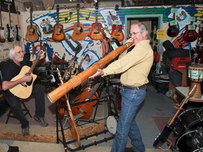 Roger Eccleston (left) and Tom Stewart play around with a few of the many instruments available at the Joe Chithalen Memorial Musical Instrument Lending Library located in the Robert Meek Community Youth centre on Bagot Street, on Wednesday. (Julia McKay/The Whig-Standard)