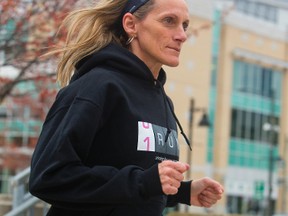 Theresa Carriere is eager to get out and run 100 kms for the third time between Sarnia and London to raise funds to support families affected by breast cancer. Carriere was at the Covent Garden Market on Thursday to raise awareness of her run. (MIKE HENSEN, The London Free Press)