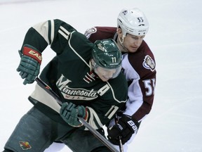 Minnesota's Zach Parise fends off Colorado's Cody McLeod during the Wild-Avs first-round series. (AFP)