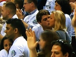 Get that gah-bage outta here! Matt Muszak tried to kiss his girlfriend, Sandra, during Game 5 between the Toronto Raptors and Brooklyn nets but missed the mark. (YouTube)