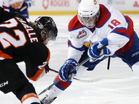 Edmonton centre Reid Petryk (18) and Medicine Hat forward Chad Labelle (22) face off during Game 5 of the 2013-14 WHL East final between Edmonton Oil Kings and the Medicine Hat Tigers at Rexall Place on Saturday, April 26, 2014. Ian Kucerak/Edmonton Sun/QMI Agency