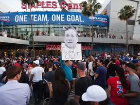 A photo cutout of Los Angeles Clippers owner Donald Sterling is seen among people standing in line for the NBA playoff Game 5 between Golden State Warriors and Los Angeles Clippers at Staples Center in Los Angeles, California April 29, 2014. (REUTERS)