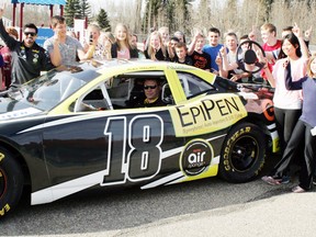 Students from Blueberry School surround a prototype race car and driver Alex Tagliani, in sunglasses at left, after a talk on allergy awareness last week at the school. - Gord Montgomery, Reporter/Examiner