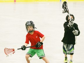Two young players from the Parkland Posse lacrosse association work on their skills last Saturday. - Gord Montgomery, Reporter/Examiner