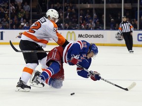 Luke Schenn #22 of the Philadelphia Flyers hits Carl Hagelin #62 of the New York Rangers in Game Seven of the First Round of the 2014 NHL Stanley Cup Playoffs at Madison Square Garden on April 30, 2014 in New York City. (Bruce Bennett/Getty Images/AFP)