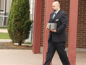 The urn contained the cremated remains of Luce Lavertu is carried to a waiting car, following the Orléans mother's funeral Friday.
DOUG HEMPSTEAD/Ottawa Sun