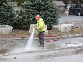 A city crew cleans a section of Frood Road on Friday. JOHN LAPPA/THE SUDBURY STAR/QMI AGENCY