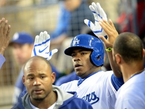 Los Angeles Dodgers right fielder Yasiel Puig (66) celebrates in the dugout after a solo home run in the first inning of the game against the Colorado Rockies at Dodger Stadium on Apr 25, 2014 in Los Angeles, CA, USA. (Jayne Kamin-Oncea/USA TODAY Sports)