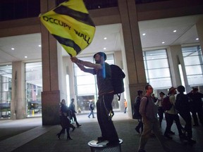 Activist Austin Guest waves a flag so others can find their group during a protest in New York May 1.

REUTERS/Andrew Burton