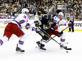 Pittsburgh Penguins centre Sidney Crosby skates with the puck as New York Rangers defensemen Marc Staal and Anton Stralman defend during Game 1 of their Eastern Conference semifinal series at the Consol Energy Center in Pittsburgh. (CHARLES LeCLAIRE/USA Today)