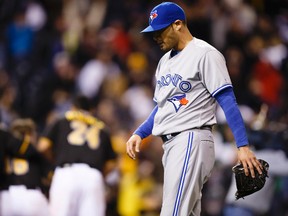 Jays pitcher Sergio Santos walks off the mound after losing against Pittsburgh on Friday. (USA TODAY SPORTS)
