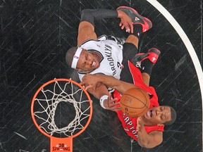 Raptors point guard Kyle Lowry fights for the ball with Brooklyn Nets’ Paul Pierce during Friday night’s Game 6. (USA TODAY SPORTS)