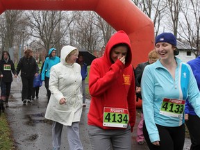 More than 30 people went for a run, or walk, in the rain at the third annual Take Back the Dusk fundraising that started in Victoria Park on Sunday. (Julia McKay/The Whig-Standard)