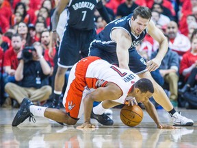 Kyle Lowry, who had his potential series-winning shot blocked in the dying seconds, scrambles for a loose ball with Nets' Mirza Teletovic. (Ernest Doroszuk, Toronto Sun)