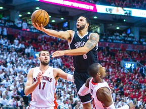 Jonas Valanciunas watches as Deron Williams drives into Terrence Ross during Game 7. JV came up small with just three points. (Ernest Doroszuk, Toronto Sun)