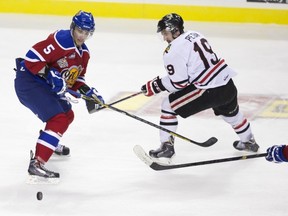 PORTLAND, OREGON-May 4, 2014--Edmonton Oil Kings Ashton Sautner (5) and Portland Winterhawks Nicolas Petan (19) go after the puck in the second period of the second game of the Western Hockey League championship series at the Moda Center in Portland Sunday. The Winterhawks lead the series, 2-0.  Photo by Randy L. Rasmussen/The Oregonian