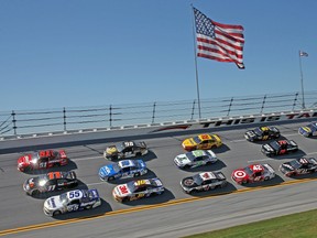 Denny Hamlin, driver of the No. 11 FedEx Express Toyota, leads the way during some three-wide racing at the Aaron’s 499 at Talladega on Sunday. (AFP)