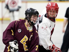 Wallaceburg Red Devils' Evan Mathany, right, battles with Brampton Excelsiors' Mark Terry in the second period Sunday at Wallaceburg Memorial Arena. (MARK MALONE/The Daily News)