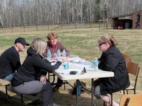 Bronwyn Taylor (left) works with volunteers to plan more searches for her missing father, Andrew Nicoll.
