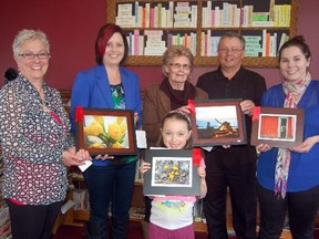 The winning photographers of the Last Light Photography Contest were recognized by the Mann family at a special show reception at the Goderich Library, Saturday. Lynne Mann (left), her husband, Steve, and daughter, Jessica (right) made the presentations in memory of their daughter and sister, Sarah Mann, who died in a car crash in 2006. The winner in the Colour Yellow category was Tracy Meurs of Lucknow, second from left, and Mary Koskela, middle, was the winner in the Life’s a Beach category. Madison Morrison, front, was the top photographer in the Under 12 category. (DAVE SYKES/SPECIAL TO THE SIGNAL STAR)