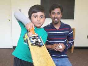Three-year-old Mirza Hashir Ahmed shows off his cricket skills as father Tahir Ahmed looks on. Tahir Ahmed is hoping city council will help him establish a proper cricket pitch in Kingston. (Michael Lea/The Whig-Standard)
