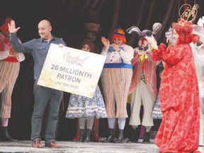 With the Red Queen Cynthia Dale and the cast of Alice Through the Looking Glass nearby, Chris Spaleta celebrates after receiving a lifetime pass for two to the Stratford Festival as its 26-millionth patron on Monday at the Avon Theatre in Stratford. (Scott Wishart/QMI Agency)