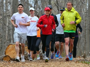 Premier Kathleen Wynne runs with supporters on the campaign trail in Milton Monday May 5, 2014. Dave Abel/Toronto Sun/QMI Agency