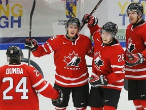 Team Canada members (from right) Griffin Reinhart, Curtis Lazar of the Oil Kings, and Nicolas Petan and Mathew Dumba of the Winterhawks, celebrate a Lazar goal at the World Junior Championship in January. All four are in the WHL final, along with Winterhawks players Taylor Leier and Derrick Pouliot. (Reuters)