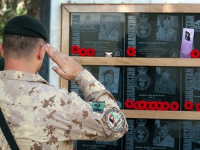 A soldier pays his respects to fallen comrades at the war memorial after the last Remembrance Day ceremony at Kandahar Air Field, November 11, 2011.  
REUTERS/Ryan Remiorz
