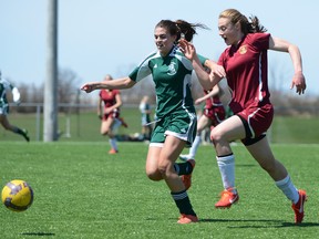 Devan Anderson, left, of Holy Cross and Bridget Mulholland of Regiopolis-Notre Dame race for the ball during a Kingston Area senior girls soccer game at John Machin Park on Monday. Regi won 3-2. (Justin Greaves/ For The Whig-Standard)