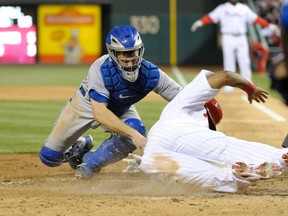 Philadelphia Phillies right fielder Marlon Byrd (right) is tagged out by Toronto Blue Jays catcher Josh Thole (left) in the sixth inning at Citizens Bank Park. (Eric Hartline-USA TODAY Sports)