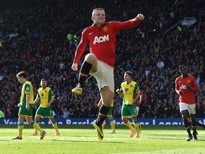 Manchester United's Wayne Rooney celebrates after scoring a second goal against Norwich during their English Premier League soccer match at Old Trafford in Manchester, northern England April 26, 2014.   (REUTERS)