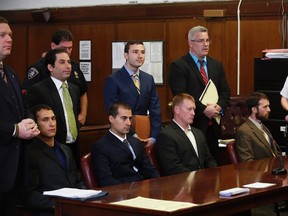 (L to R seated) Andrew Rossig, Marco Markovich, James Brady and Kyle Hartwell appear in Manhattan Criminal Court in New York May 6, 2014. The Group appeared on charges for base jumping off 1 World Trade Center.  

REUTERS/Brendan McDermid