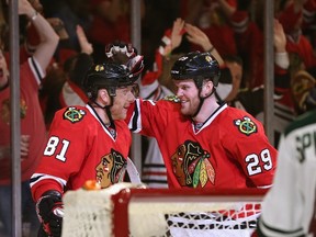 Marian Hossa and Bryan Bickell of the Chicago Blackhawks celebrate Hossa's second period goal against the Minnesota Wild in Game 1 at the United Center on May 2, 2014. (Jonathan Daniel/Getty Images/AFP)