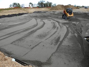 Placement of bottom-ash as insulation layer to prevent frost penetration into the pavement  during construction, summer 2012. Tire Derived Aggregate (TDA) and bottom ash used in a pilot Edmonton pilot test road. For this project, nearly one million scrap tires in Alberta to produce roughly 8,000 tonnes of (TDA) to be used as embankment fill material. Photo Supplied