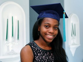 Grace Bush poses in her university graduation cap at her home in West Park, Florida, May 6, 2014. (REUTERS/Andrew Innerarity)