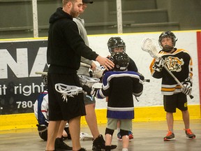 Ryan Dilks of the Edmonton Rush talks to a young Vermilion Roar player during practice last week.
