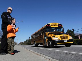 Michael Grisius and his son Anthony pose for a photo on Innes Road on Tuesday, May 6, 2014. Anthony's bus driver dropped him off at the wrong stop, alongside a busy road, which has upset his parents. 
Tony Caldwell/Ottawa Sun/QMI Agency