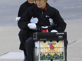 Robert Hall, shown here with his wife, used a scooter to get around during his trial in London in November, 2010. (File photo)