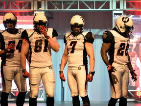 (L-R) Ottawa Redblacks #54 Kevin Scott, #81 Patrick Lavoie, #7 Eric Fraser and #29 Chevon Walker helped unveil their away uniforms in Ottawa on Tuesday, May 6, 2014. (Matthew Usherwood/ Ottawa Sun)