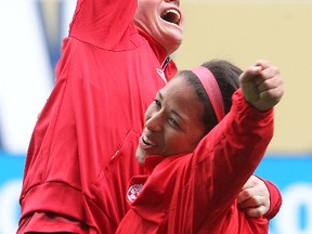 Team Canada soccer players Desiree Scott (r) and Diana Matheson celebrate during practice in Winnipeg in 2014. The national women's team has been setting the bar high and blazing a trail for youth soccer players across the country. 
Brian Donogh/Winnipeg Sun/QMI Agency