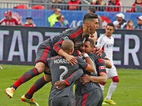 TFC celebrates after scoring the first goal of the game against New England on Saturday. The Reds face Vancouver on Wednesday night. (VERONICA HENRI/Toronto Sun)